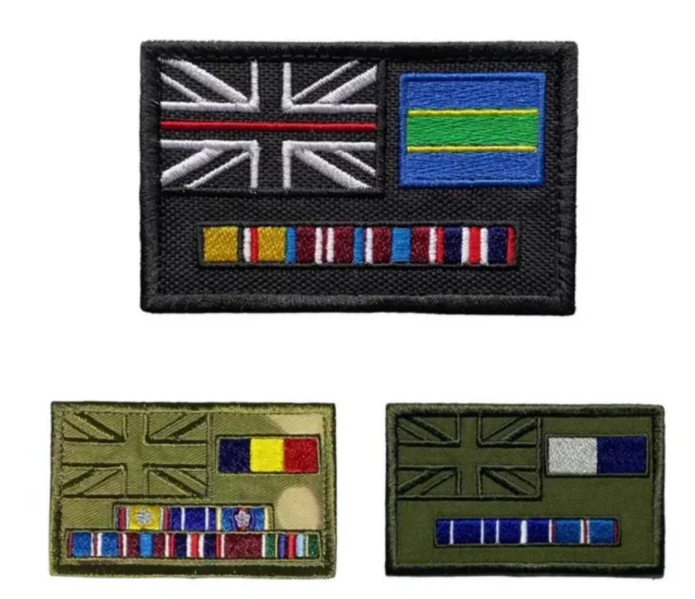 Three embroidered military-style patches shown on a plain white background: one large black patch at the top with a Union Jack with a red stripe, a blue-and-green panel, and multiple service ribbons; two smaller olive green patches below, one with a Union Jack, a yellow/red/blue flag, and ribbons, and one with a Union Jack, a blue/white flag, and ribbons.